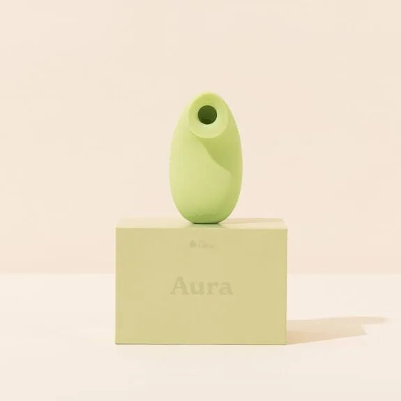 Stimulateur intime vert pastel en silicone, design ergonomique.