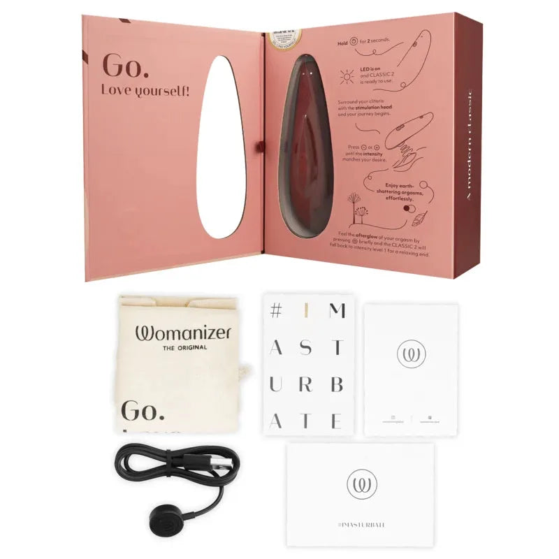Stimulateur intime Womanizer Classic avec accessoires, design élégant et fonction clitoridienne innovante.